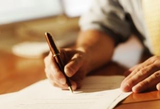 Applicant signing legal document