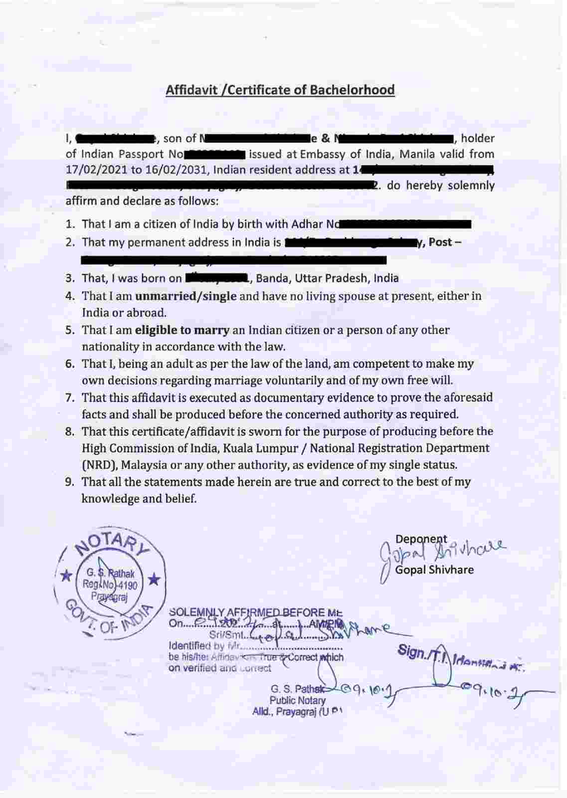 Notarized bachelorhood affidavit stating single status, signed and stamped by a Prayagraj notary.